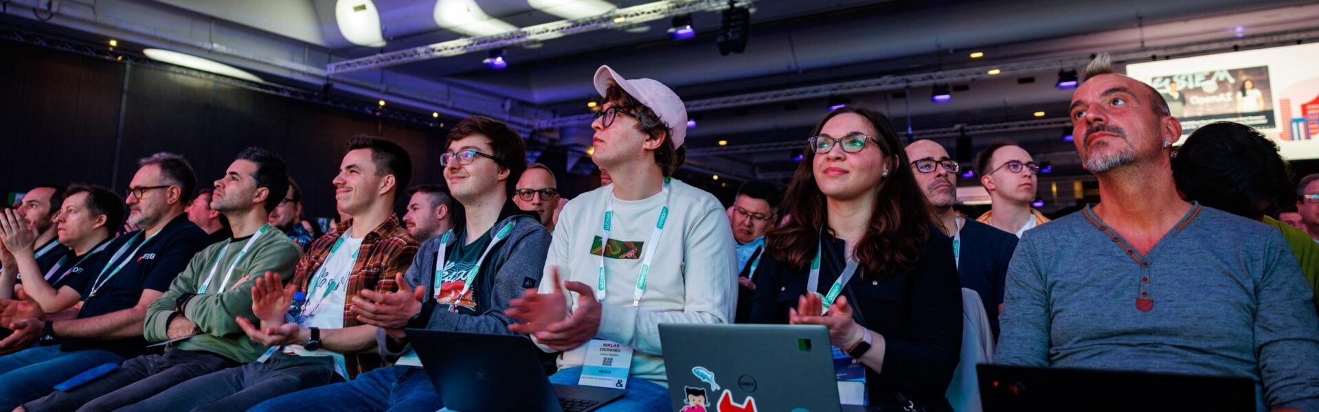 A crowd of attendees listening to a keynote speaker.