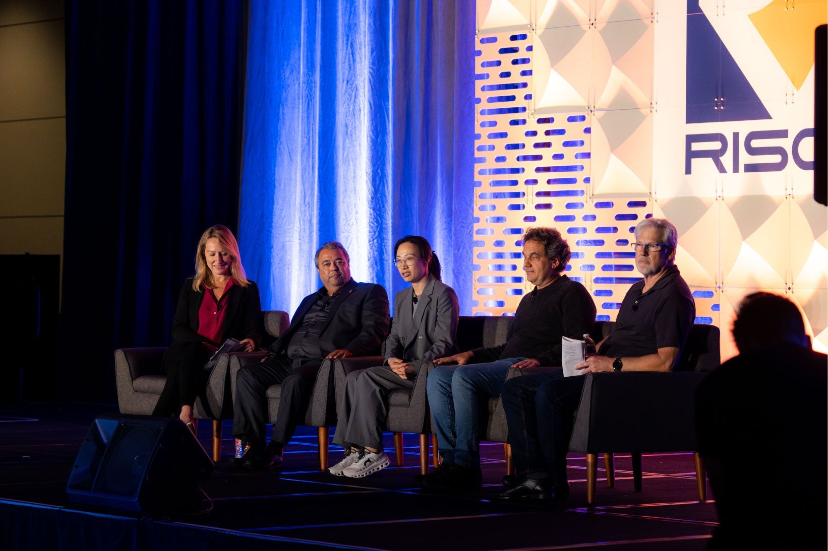 Panel of five people sitting on a stage at the RISC-V conference.